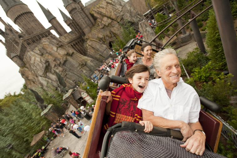 Image: Academy award-winning actors Douglas and wife Zeta-Jones, along with their children ride over The Wizarding World of Harry Potter and past Hogwarts Castle at Universal Orlando Resort